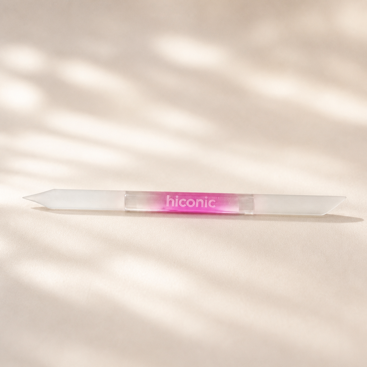 Hiconic glass cuticle pusher with pink gradient handle, front view