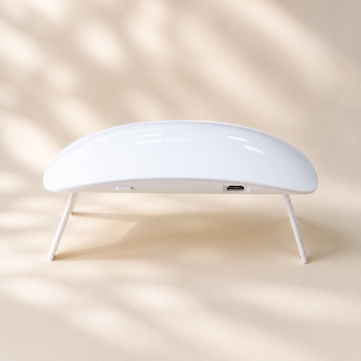 Hiconic mini LED nail lamp, front view, folding legs open