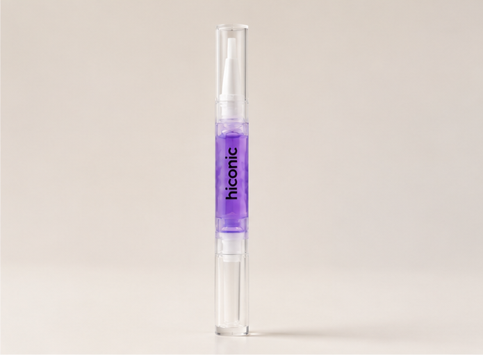 Hiconic nail and cuticle oil pen standing upright with lavender oil visible