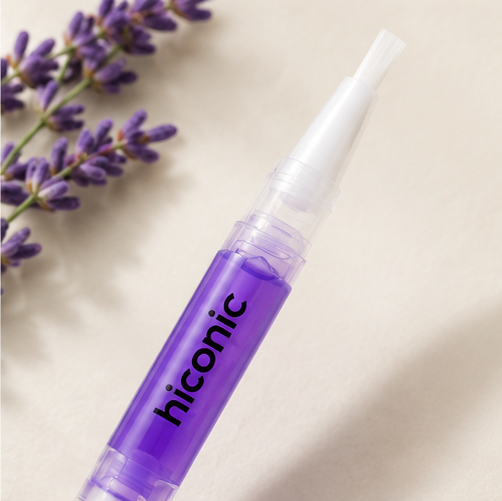 Close-up of the Hiconic cuticle oil brush tip beside fresh lavender
