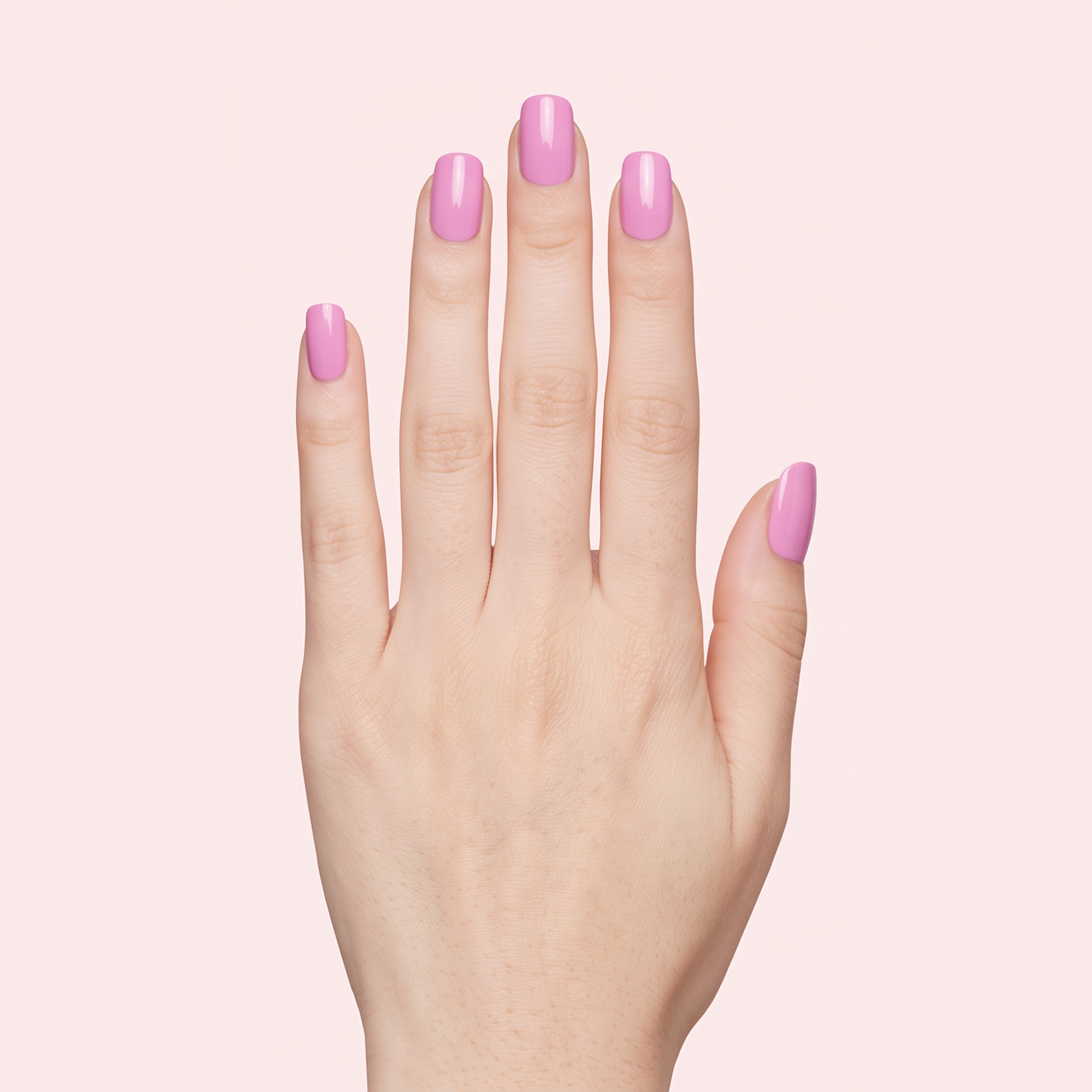 Orchid pink gel nail strips worn on a light skin tone hand