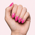Fuchsia pink gel nail strips worn on a light skin tone hand