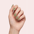 Sage olive green gel nail strips worn on a light skin tone hand