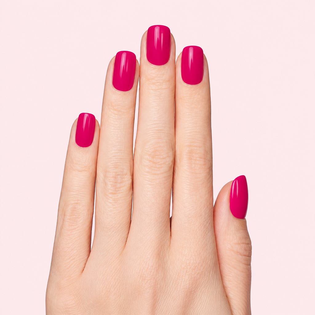 Raspberry pink gel nail strips worn on a light skin tone hand