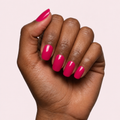Raspberry pink gel nail strips worn on a deep skin tone hand