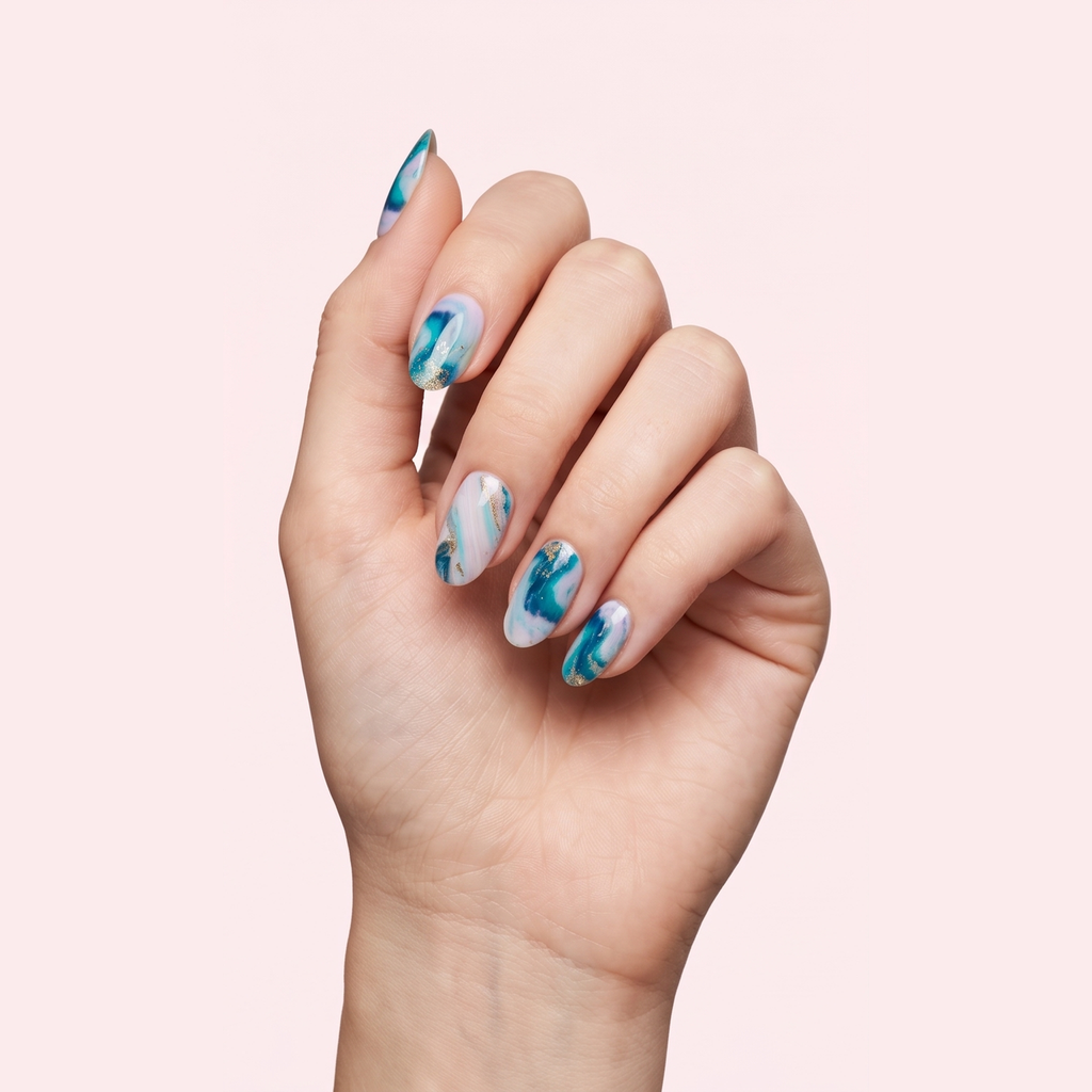 Blue and white marble swirl gel nail strips worn on a light skin tone hand