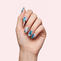 Blue and white marble swirl gel nail strips worn on a light skin tone hand