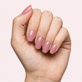 Dusty rose mauve gel nail strips worn on a light skin tone hand