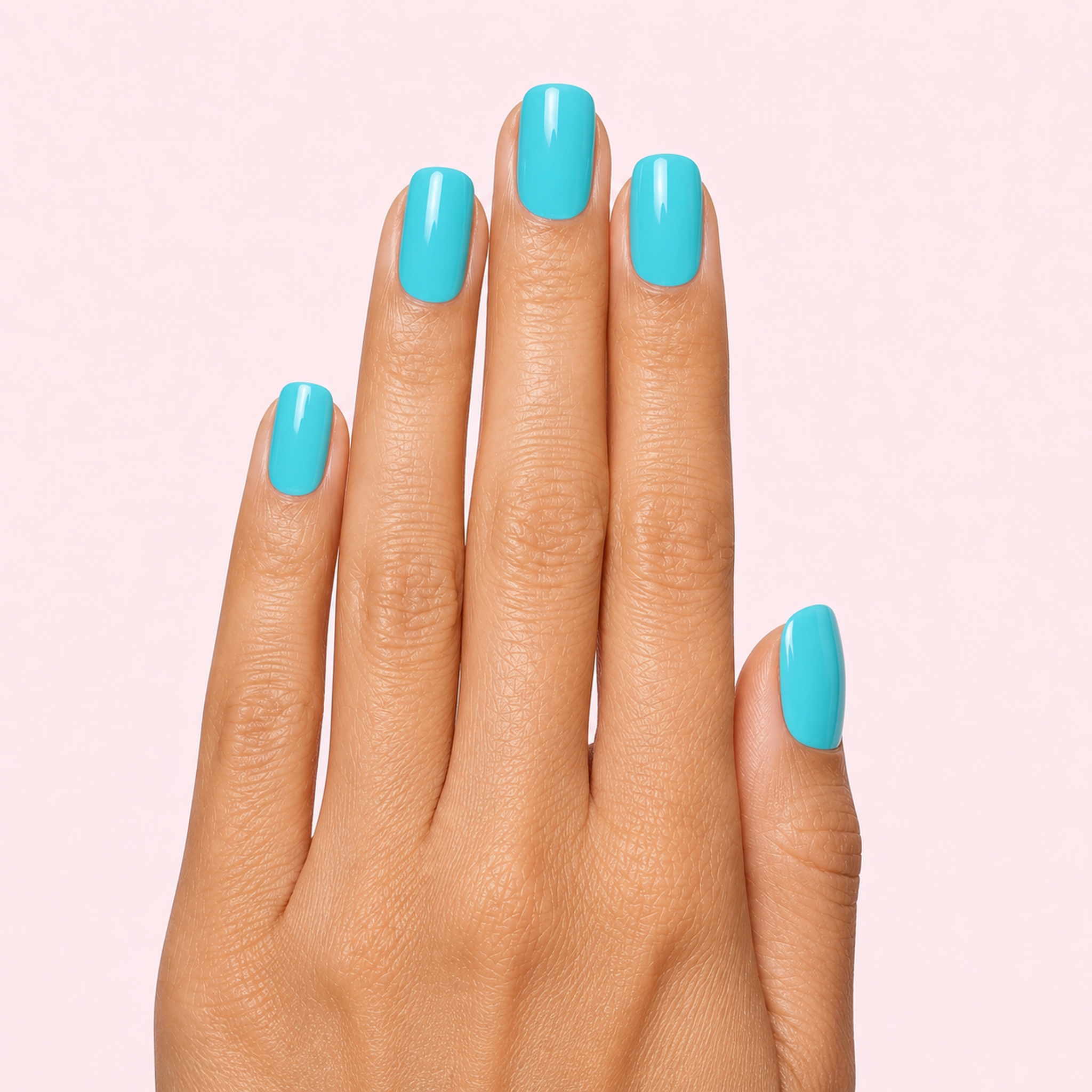 Turquoise aqua blue gel nail strips worn on a tan olive skin tone hand