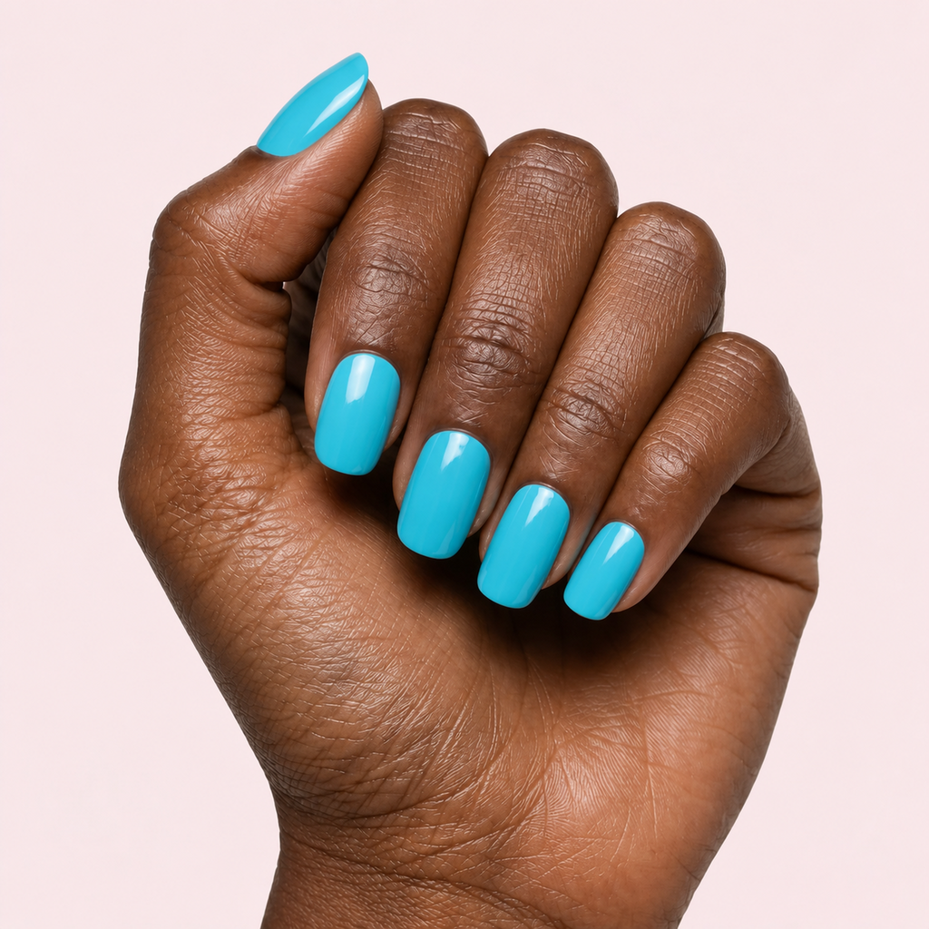 Turquoise aqua blue gel nail strips worn on a deep skin tone hand