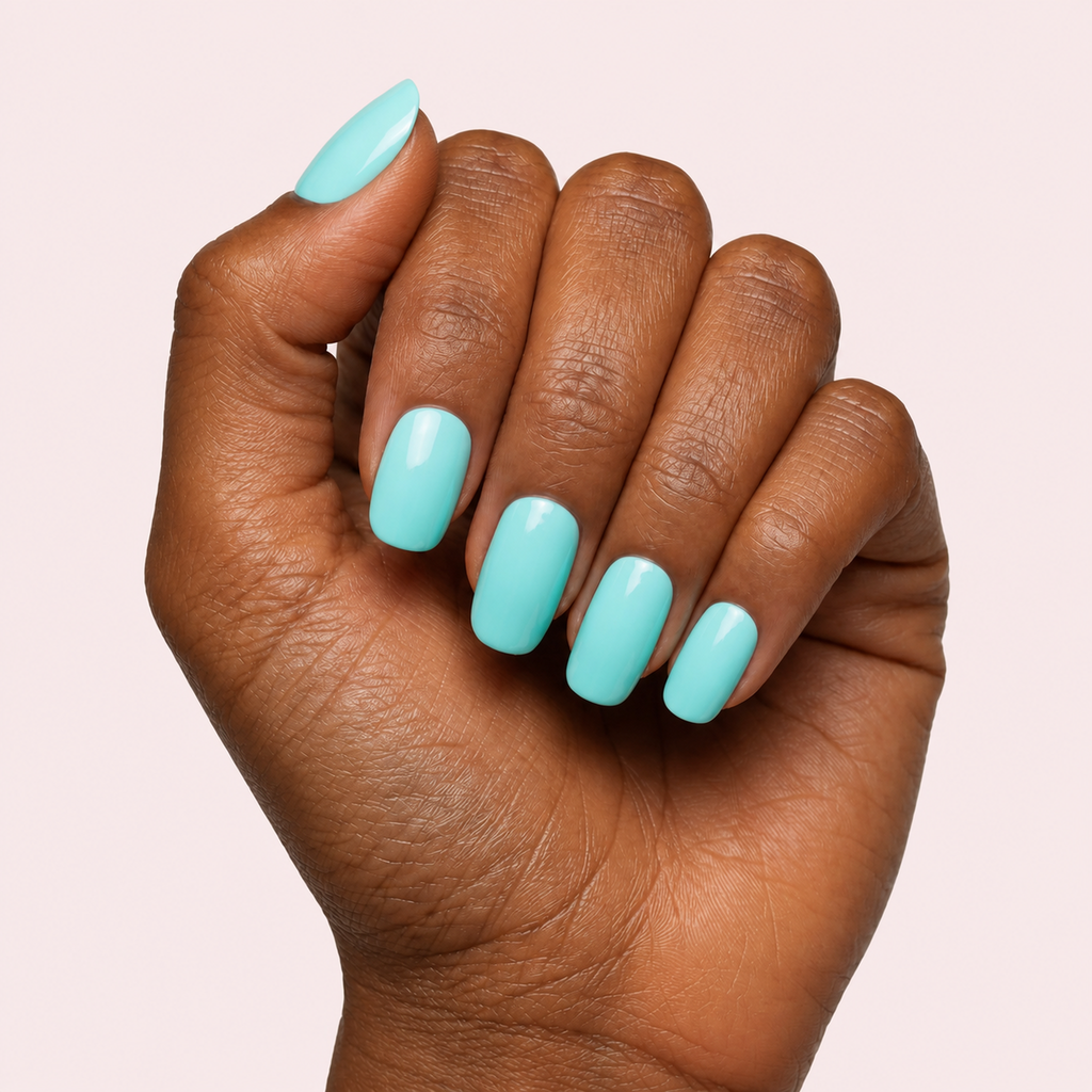 Mint green pastel gel nail strips worn on a deep skin tone hand
