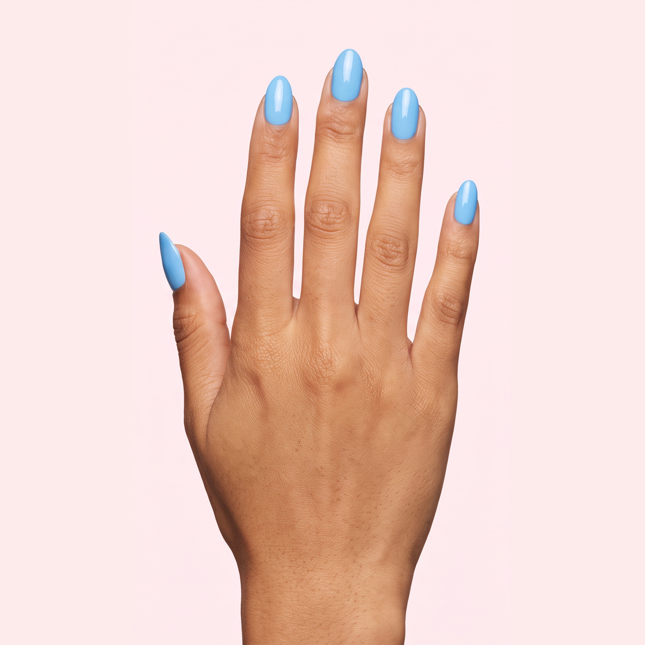 Sky blue glossy gel nail strips worn on a tan olive skin tone hand