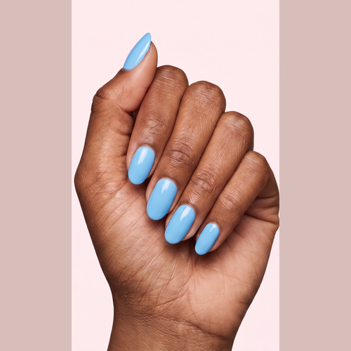 Sky blue glossy gel nail strips worn on a deep skin tone hand