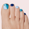 Blue marble mix gel toenail strips with navy and silver detail worn on a light skin tone foot